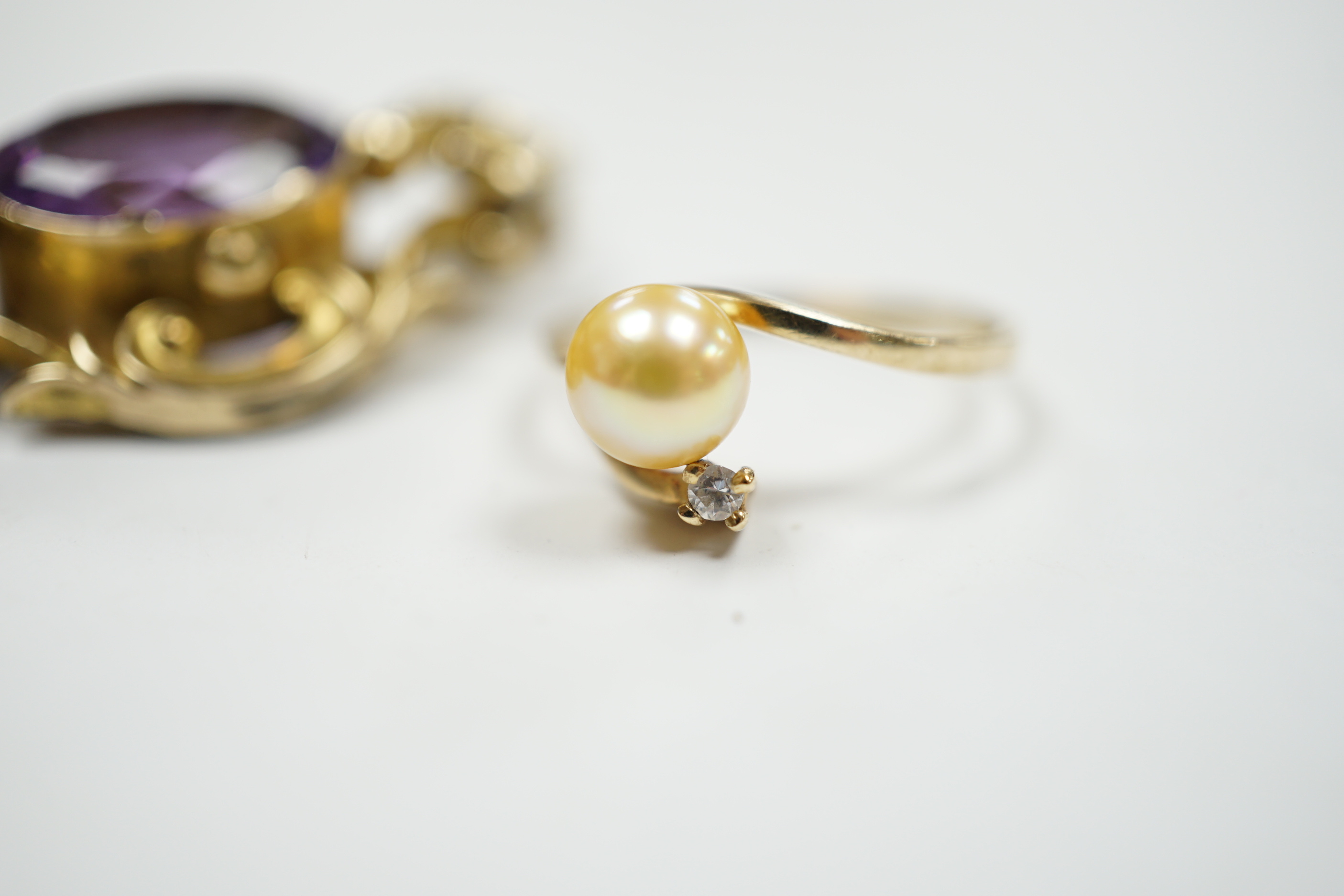 A late Victorian yellow metal mounted amethyst brooch, 38mm pendant and a 10k, cultured pearl and diamond set two stone ring.